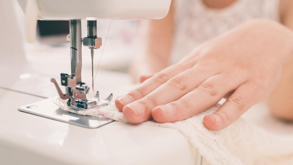 Image Showing Sewing machine operater using the industrial sewing machine.