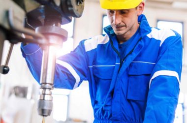 An industrial engineer operating the manufacturing robotic system.