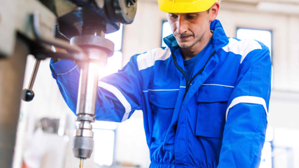 An industrial engineer operating the manufacturing robotic system.